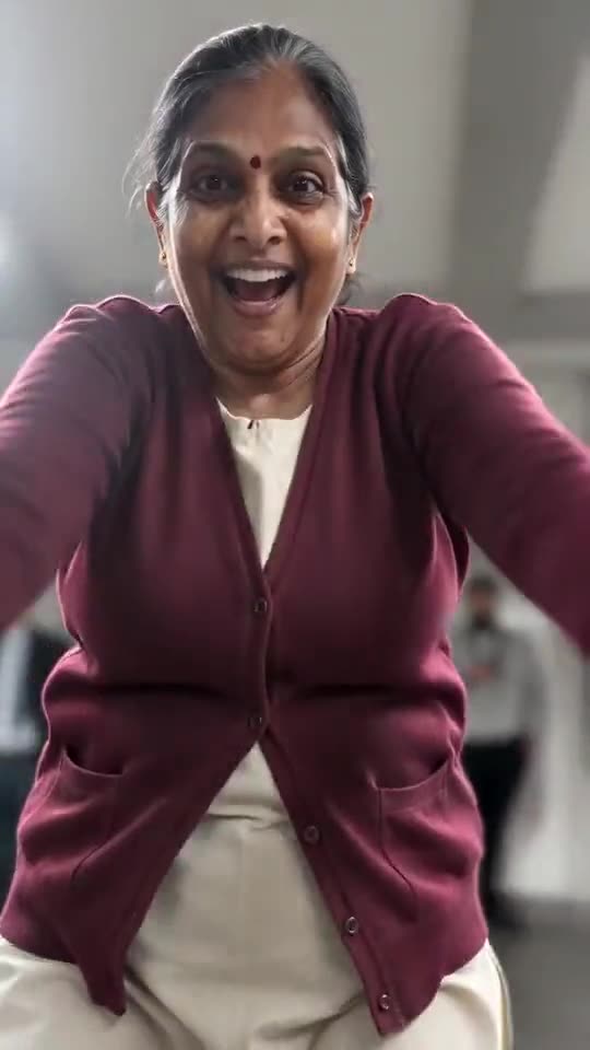 Example frame: a woman in a maroon cardigan on a station platform, hands clutching her head and shouting at the camera